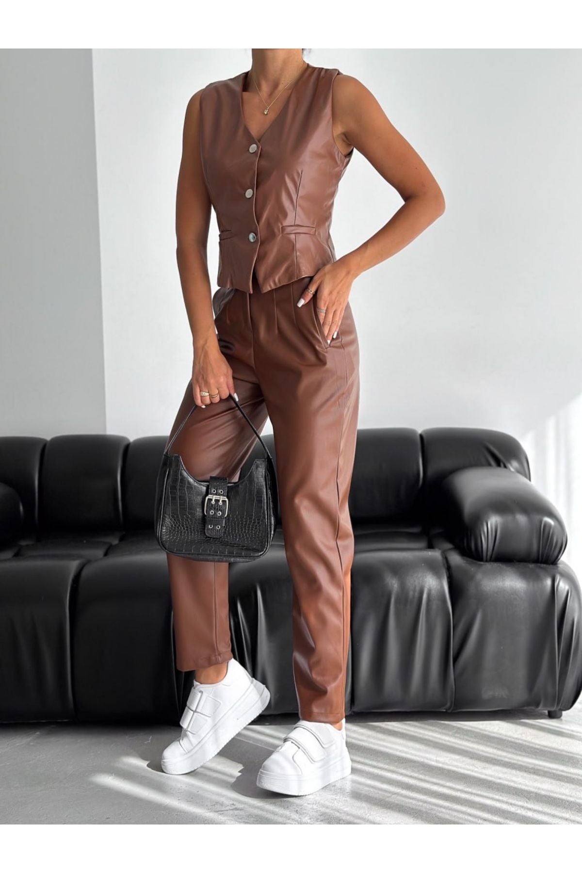 Aec Prive şardonlu siyah deri pantolon rahat bir kombinle sunulmuş, spor ayakkabılarla tamamlanmış