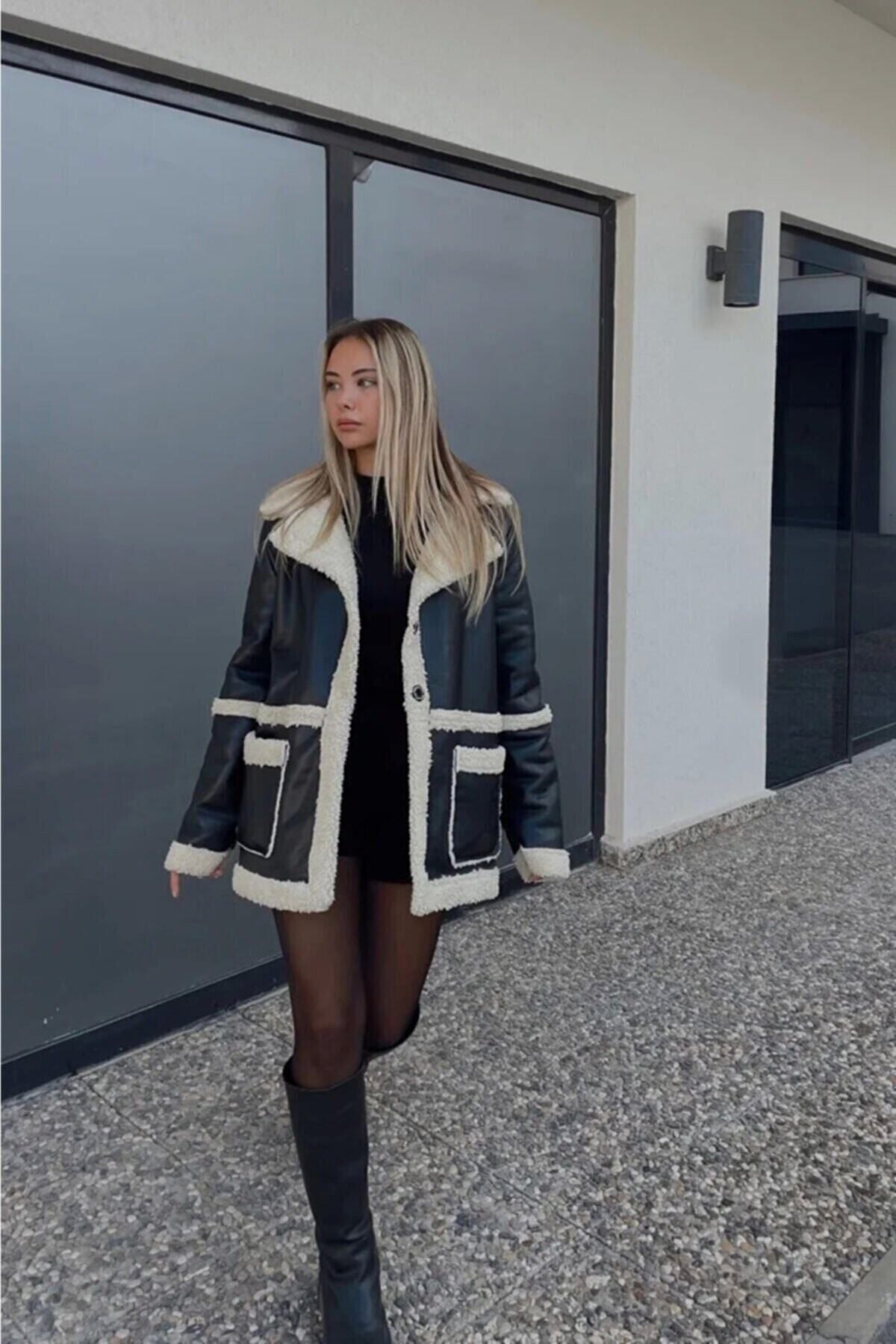 Içi kürklü siyah deri mont ile şık ve rahat görünüm sunan kadın modası