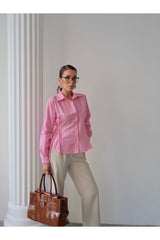 Aec Prive kadın trend gömlek ile şık kombin yapmış model, bej pantolon ve kahverengi çanta ile poz veriyor